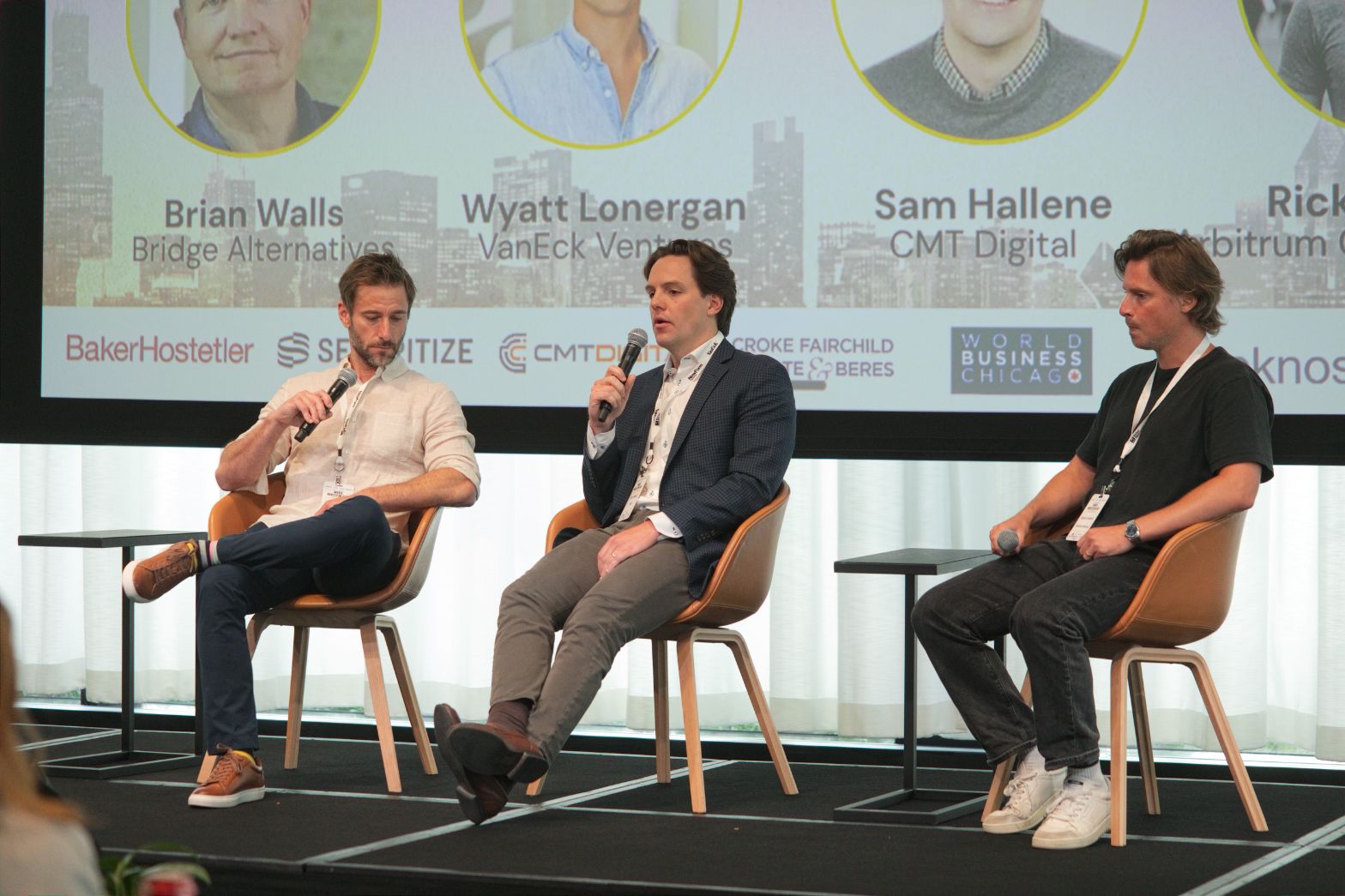 Three State of VC panelists seated on stage, with the center panelist speaking into a microphone at Web3 Investor Day 2026