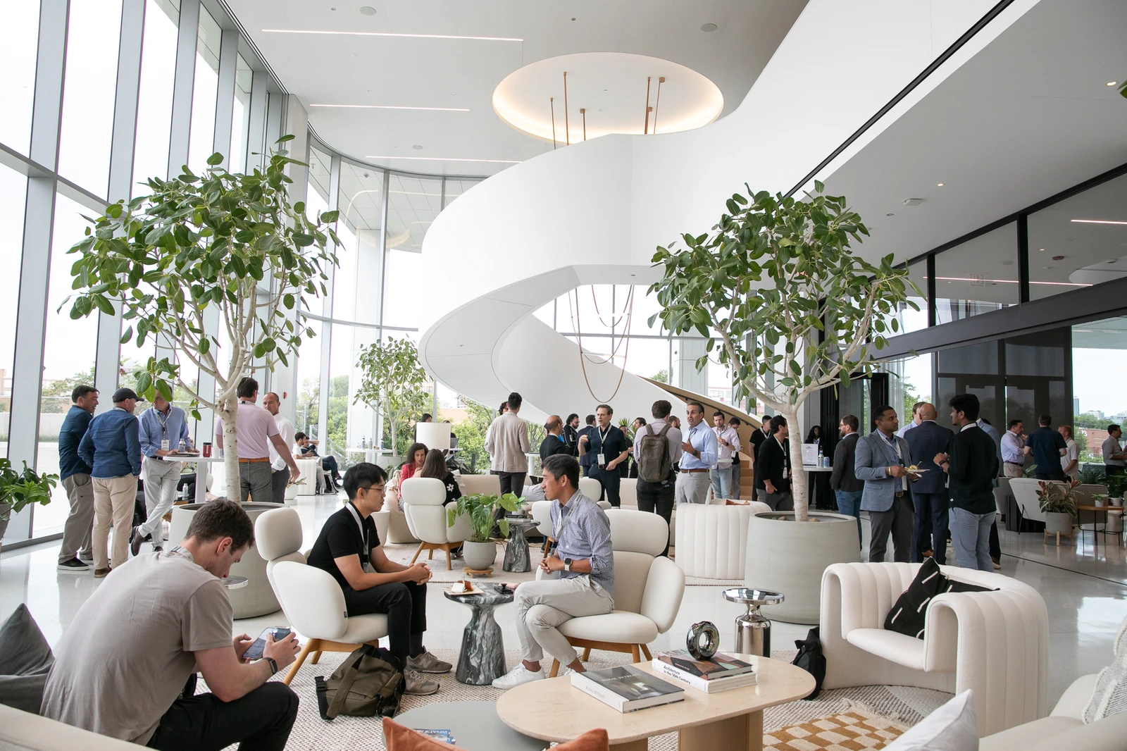 Investors and founders connecting in a sunlit lobby at Web3 Investor Day 2024.